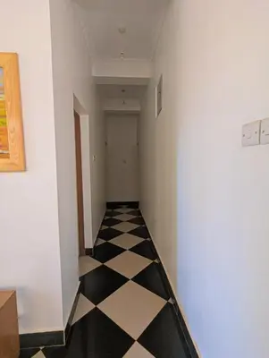 a hallway with a black and white checkered floor at Horizon Kili Retreat in Moshi