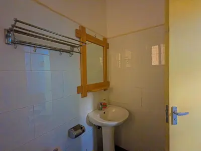 a bathroom with a white sink and a mirror at Horizon Kili Retreat in Moshi