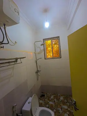 a bathroom with a toilet and a window at Horizon Kili Retreat in Moshi
