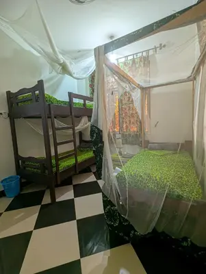 a bedroom with two bunk beds and a checkered floor at Horizon Kili Retreat in Moshi