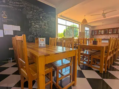 a dining room with wooden tables and chairs at Horizon Kili Retreat in Moshi