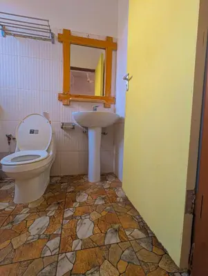 a bathroom with a toilet and a sink at Horizon Kili Retreat in Moshi
