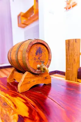a wooden wine barrel sitting on top of a wooden floor at Kaya homestay in Zame