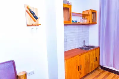 a small kitchen with a sink and a counter at Kaya homestay in Zame