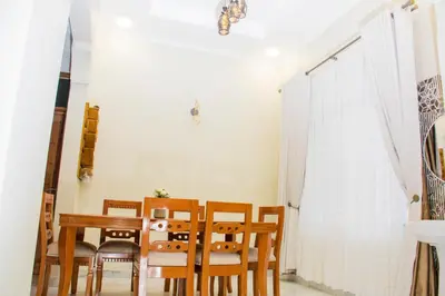 a dining room with a table and chairs at KiliView Homestay in Moshi
