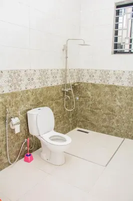 a bathroom with a toilet and a shower at KiliView Homestay in Moshi