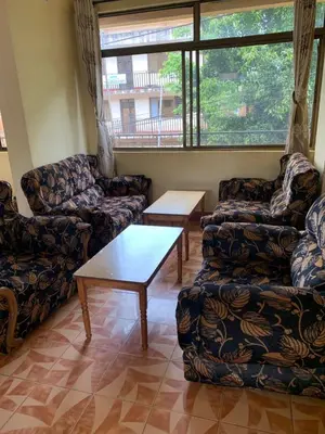 a living room with couches and a coffee table at Golden View Hotel in Moshi