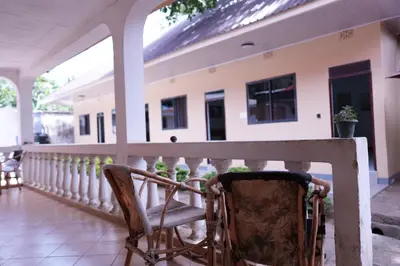 a chair sitting on the porch of a house at Hotel near the clock tower in Arusha
