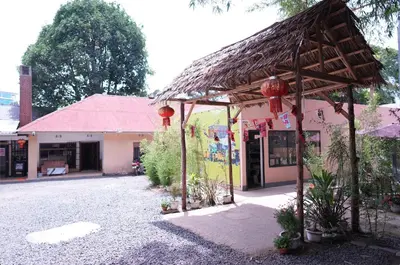 a building with a thatched roof in front of a street at Hotel near the clock tower in Arusha