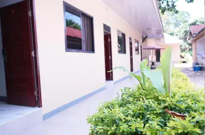 a building with a door and plants in front of it at Hotel near the clock tower in Arusha