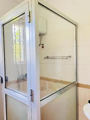 a glass door to a shower in a bathroom at Aviator Safari bnb in Arusha