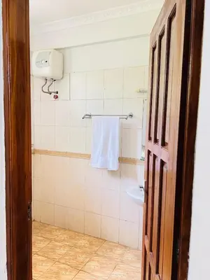 a bathroom with a towel hanging on the wall at Aviator Safari bnb in Arusha
