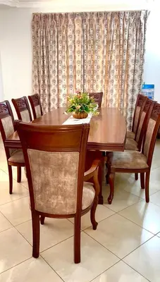a wooden table and chairs with a plant on it at Aviator Safari bnb in Arusha