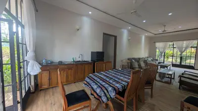 a dining room with a table and chairs in a room at Dawson's Homestay in Msaranga