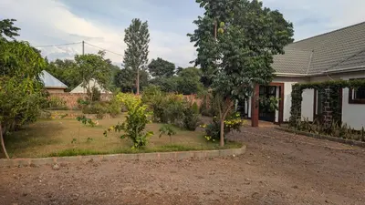 a garden in front of a house at Dawson's Homestay in Msaranga
