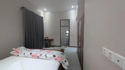 a small bedroom with a bed and a hallway at Dawson's Homestay in Msaranga