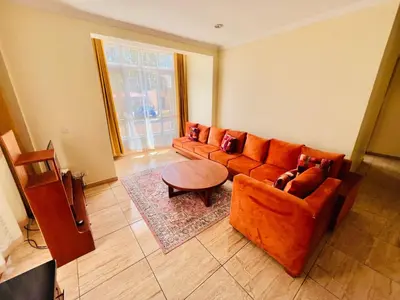 a living room with a couch and a table at JJ Comfort Homes in Arusha
