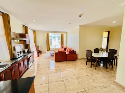 a kitchen and living room with a couch and a table at JJ Comfort Homes in Arusha