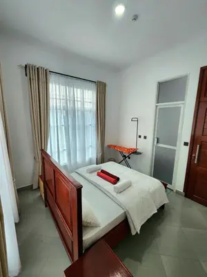 a bedroom with a large bed with a window at Karibu Haven Apartments in Arusha