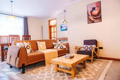 a living room with a couch and a coffee table at LEGIT HOUSE Arusha in Arusha