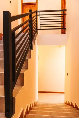 a staircase in a house with wooden railings at LEGIT HOUSE Arusha in Arusha
