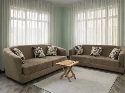 a living room with two couches and a coffee table at Oltare House in Makuyuni