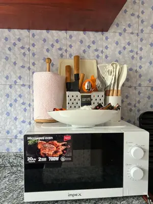 a microwave with a bowl on top of it at Lululiving Homes in Arusha