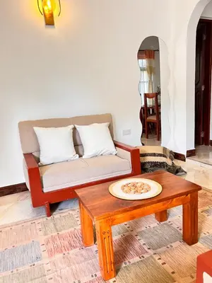a living room with a couch and a coffee table at Lululiving Homes in Arusha