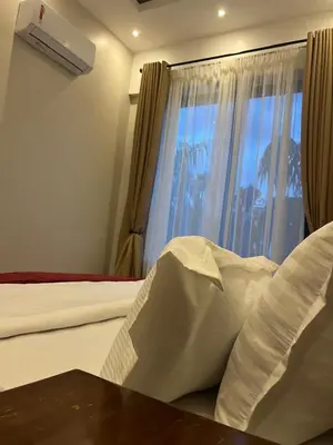a hotel room with a bed and a window at Vista Montage Homestay in Uru