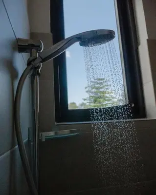 a shower in a bathroom with a shower head at Vista Montage Homestay in Uru