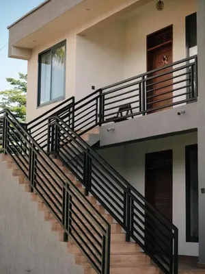 a balcony of a house with black railing at Vista Montage Homestay in Uru