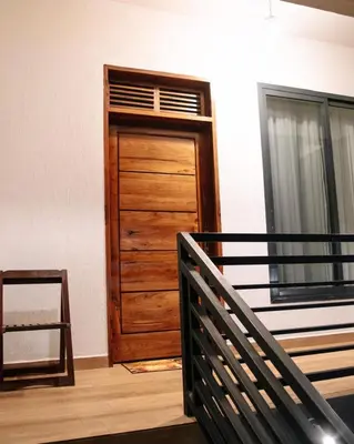 a wooden door in a room next to a window at Vista Montage Homestay in Uru