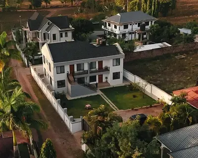 an aerial view of a house with a white fence at Vista Montage Homestay in Uru