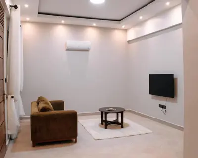 a living room with a chair and a tv at Vista Montage Homestay in Uru