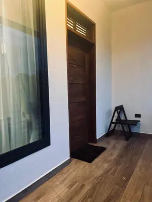 a room with a door and a wooden floor at Vista Montage Homestay in Uru