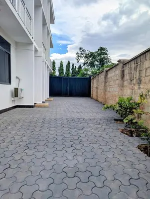 an empty courtyard of a house with a fence at Kiliscape Abode in Uru