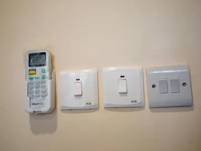 a cell phone is hanging on a wall at Kiliscape Abode in Uru