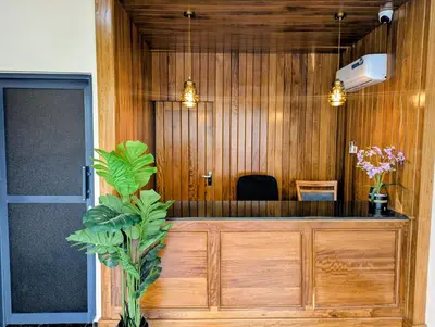 a waiting room with wooden walls and a desk at Kiliscape Abode in Uru