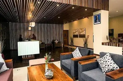 a living room with couches and a coffee table at Venus Premier Hotel in Arusha