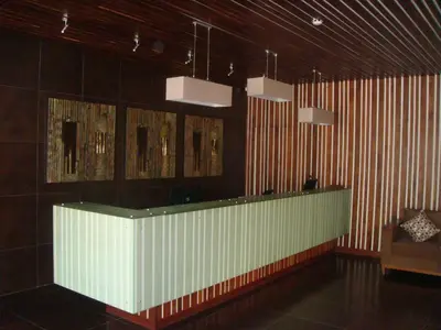a lobby with a white counter in a room at Venus Premier Hotel in Arusha