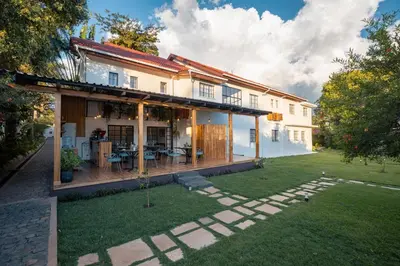 a house with a patio and a yard at Brubru Lodge in Moshi