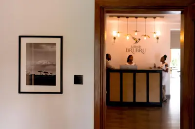 a room with a bar with people sitting at a counter at Brubru Lodge in Moshi