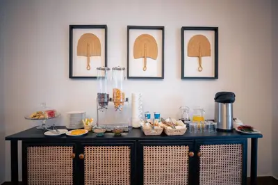a table with food on it with pictures on the wall at Brubru Lodge in Moshi