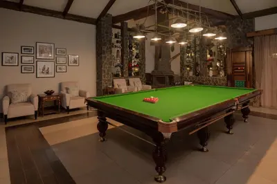 a billiard room with a green pool table at Ngorongoro Oldeani Mountain Lodge in Oldeani