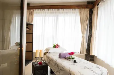 a bedroom with a bed with flowers on it at Ngorongoro Oldeani Mountain Lodge in Oldeani