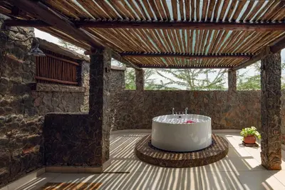 a large white tub sitting on top of a patio at Ngorongoro Oldeani Mountain Lodge in Oldeani