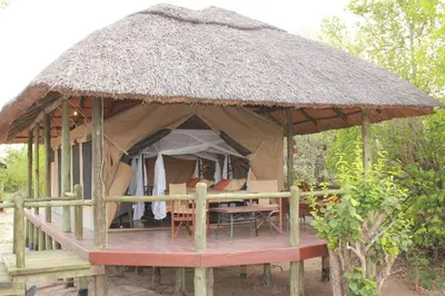 a tent with a table and chairs in it at Mbali Mbali Tarangire River Camp in Kwa Kuchinia