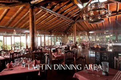 a restaurant with tables and chairs in a room at Lake Manyara Wildlife Lodge in Mto wa Mbu