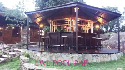 a building with a bunch of stools in front of it at Lobo Wildlife Lodge in Serengeti