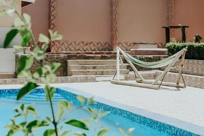 a hammock sitting next to a swimming pool at Viva Tanzania in Arusha